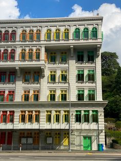 an old building with multi - colored windows and shutters on the front is shown