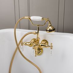 a gold faucet is attached to the side of a bathtub