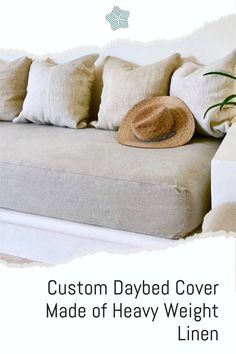 a couch with some pillows and a hat on it's back cover that says custom daybed cover made of heavy weight linen