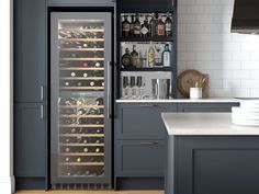 a wine cooler in the middle of a kitchen