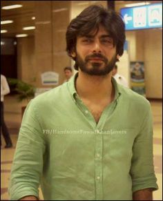 a man standing in an airport looking at the camera