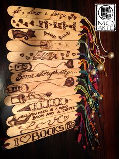 several wooden paddles with writing on them and beads hanging from the handles, along with other decorative items