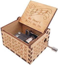 a wooden music box with musical notes engraved on it