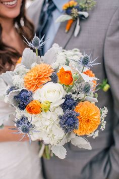 a bride and groom holding a bouquet of flowers