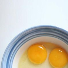 two eggs in a blue and white bowl