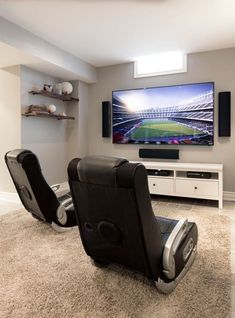 two chairs facing each other in front of a television with a soccer game on it