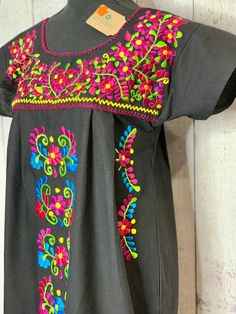 Black Floral Manta Mexican Dress. Beautiful embroidery can be dressed up or wear with sandals. Please feel free to contact us with any questions. Measurements upon request. Traditional Black Embroidered Dress For Fiesta, Black Embroidered Dress For Fiesta With Floral Details, Black Embroidered Dress For Fiesta, Mexican Dress, Mexican Dresses, Beautiful Embroidery, Dress Beautiful, Girls Trip, How To Take Photos