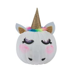 a white pumpkin with a unicorn face painted on it's side and a gold glitter horn