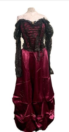 This is a rare vintage Raven outfit. The top has gathered black lace sleeves which can be worn both on  or off the the shoulders. The top has a zip in the back and medium fits a chest 34/36 inch .  The skirt it a plum satin and has an elasticated waist with a zip . Fits Up to a 36 inch waist. It also comes with a cameo brooch with diamanté . Thank you for looking Fitted Gothic Victorian Dress With Lace Trim, Gothic Victorian Long Sleeve Dress For Costume Party, Halloween Corset Dress With Lace Trim For Costume Party, Gothic Lace Trim Corset Dress For Costume, Gothic Lace Corset Dress For Costume, Gothic Victorian Dress For Costume Party, Victorian Corset Dress For Costume Party, Vintage Victorian Dress For Halloween Party, Gothic Long Sleeve Corset Dress For Evening