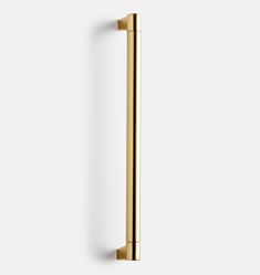 an image of a gold door handle on a white wall