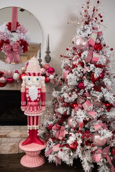 a decorated christmas tree next to a fire hydrant with santa clause on it and other decorations