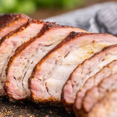 sliced meat sitting on top of a cutting board