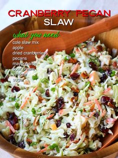 a wooden bowl filled with coleslaw and cranberry pecan slaw