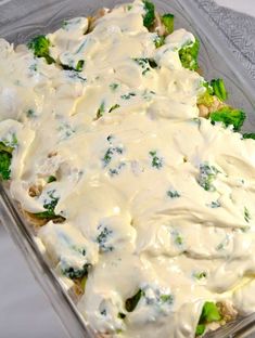 a casserole dish with broccoli and white sauce on the top is ready to be eaten