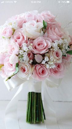 a bouquet of pink roses and white flowers