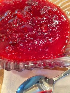 a pie sitting on top of a glass plate covered in saucer and spoons