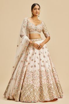 Blush pink lehenga with attached cancan and resham, zari, dabka, sequin, crystal embroidery in floral pattern. Paired with padded blouse and dupatta. Components: 3 Pattern: Embroidery Type Of Work: Resham, zari, dabka, sequin, crystal, floral Neckline: Leaf neck Sleeve Type: Half Fabric: Lehenga and Blouse: Raw Silk, Dupatta: Net Color: Pink Other Details:  Lehenga Length: 45 inches Back tassel tie-up Sheer embroidered dupatta Occasion: Bride - Aza Fashions Pink Raw Silk Lehenga, Lehenga And Blouse, Lehenga Pattern, Raw Silk Lehenga, Zardozi Embroidery, Crystal Embroidery, Navy Blue Print, Green Lehenga, Padded Blouse