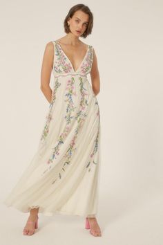 Exquisite floral embroidery adorns this elegant maxi dress Plunging V-neckline adds an alluring touch Sleeveless design with adjustable straps for a customized fit Flowing maxi length skirt creates a graceful silhouette Lightweight fabric drapes beautifully for effortless movement Radiate feminine charm at your next special occasion in this stunning embroidered maxi dress. The intricate floral detailing exudes a romantic aesthetic, while the plunging neckline and sleeveless cut offer a touch of modern allure. Pair it with delicate jewellery and strappy heels for a refined look that's perfect for formal events, weddings, or evening soirées. With its flowing skirt and lightweight fabric, this dress will have you gliding through the night in style and comfort. Embroidered Maternity Dress, Womens Bridesmaid Dresses, Plunge Maxi Dress, Delicate Jewellery, Maxi Dress Designs, Romantic Aesthetic, Maxi Dress Collection, Oasis Dress, Cami Maxi Dress