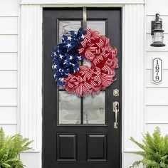 a patriotic wreath on the front door of a house