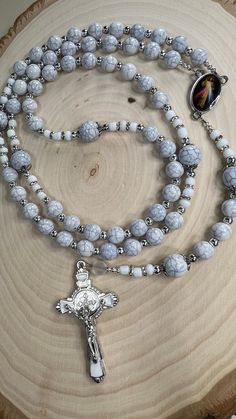 "Rosary of Jesus of Mercy made with light beads, 6mm and 8mm beads were used for the mysteries, the mysteries beads have a silver cap, 4mm silver spacers were used in addition to 6/0 Glass seed Beads white opaque Matte, the centerpiece of the rosary is of the Jesus of Mercy Mercy measuring 1\" or 2.5 cm, the rosary crucifix is in white and silver measuring 2\" or 2.5 cm. The measurement of the rosary is 22.5 inches or 57 cm. Beautiful instrument of prayer or to give as a gift." White Spiritual Rosary Bracelet With 8mm Beads, Spiritual White Rosary Bracelet With Round Beads, White Crucifix Rosary With Miraculous Medal, White Spiritual Rosary With Miraculous Medal, Spiritual White Rosary With Miraculous Medal, Handmade White Spiritual Rosary, White Rosary With 8mm Beads Crucifix, Adjustable White Rosary With 108 Beads, White Rosary With Round Beads For Meditation