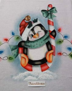 a penguin with a scarf and hat holding a candy cane