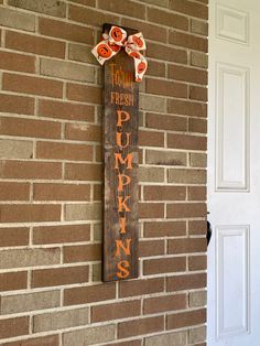 a sign on the side of a brick building that says, this is fresh pumpkins