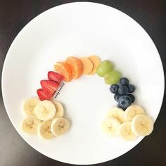 a white plate topped with sliced up fruit