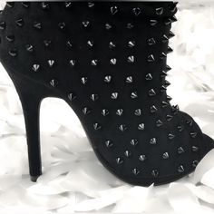 These Slouchy Booties Feature A Peep Toe Silhouette, Spikes Embellished Shaft, Low Platform, And Wrapped Stiletto Heel. Finished With A Cushioned Insole, Soft Lining, And Easy Pull On Construction. Measurement Heel Height: 4.75″ (Approx) Shaft Length: 10.5″ (Including Heel) Top Opening Circumference: 12″ (Approx) Please Note This Style Runs Small And We Recommend Ordering Half Size Up From Your Normal Size. Spiked Round Toe Heeled Boots, Casual Ankle-high Spike Boots, Black Open Heel Spiked Heels, Chic Ankle-high Spiked Heels, Edgy Spiked Ankle-high Heels, Bootie Boots, Stiletto Heels, Heel Height, Ankle Boots