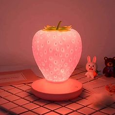 a strawberry shaped light sitting on top of a table