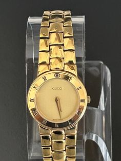 Gucci beautiful women's  6 1/2"  gold link timepiece, Swiss made and pre-owned with a new battery, gives precise time, with a wonderful new crystal, and recently serviced by a professional  jeweler. Serial number  embossed @ back base and 100% authentic guaranteed. with light scratches @ bezel, link bracelet and back base. with a gold  dial on gold tones, Model 33002l  and a 25mm case (the dial is the size of a nickel) Please view my 100% positive reviews it tells my history. with same day secure, fast shipping, Thank you for your consideration. Gold-tone Quartz Watch For Formal Occasions, Gold Link, Swiss Made, Link Bracelets, Time Piece, Wrist Watch, Gold Tones, Gucci, Bracelet