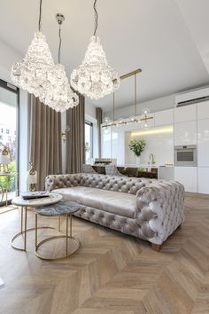 a living room filled with furniture and chandeliers