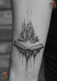 an open book with a castle on it and dripping water coming out of the pages