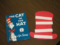 the cat in the hat and dr seuss book are sitting on a wooden table