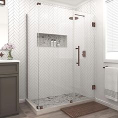 a bathroom with a walk in shower next to a sink