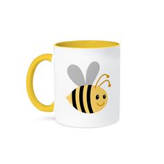 a yellow and white coffee mug with a smiling bee on it's front side