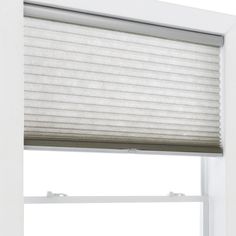 an open window with white blinds on it