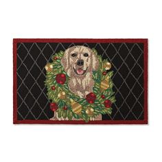 a door mat with a dog on it and holly wreaths around the edges, in front of a black background