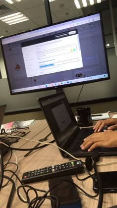 two people working on their laptops at a desk