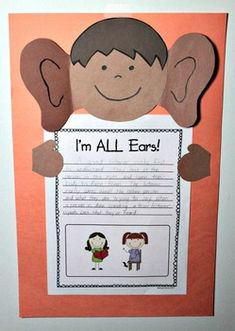 a paper cut out of a boy and girl holding an i'm all ears sign