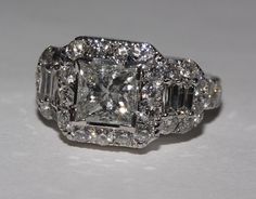 a diamond ring with three stones on the sides and two rows of diamonds in the middle