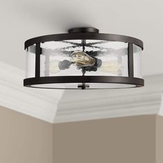 a light fixture in a room with white walls and ceiling paint on the wall behind it