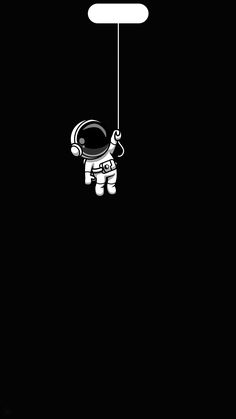 an astronaut floating in the air on a string