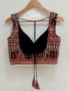 Black Sleeveless Choli For Festive Occasions, Sleeveless Black Choli For Festive Occasions, Black Sleeveless Choli For Wedding, Embroidered Sleeveless Choli, Sleeveless Blouse With Multicolor Embroidery For Festivals, Embroidered Sleeveless Tops For Navratri, Traditional Black Sleeveless Blouse, Traditional Sleeveless Embroidered Top For Festive Occasions, Fitted Sleeveless Blouse With Intricate Embroidery