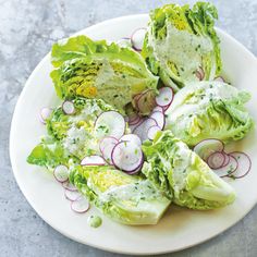 lettuce and radishes on a plate with dressing