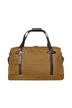 An overnight bag with a reinforced base and exterior pockets. Filson's 48-Hour Tin Cloth Duffle Bag is ideal for overnight and weekend trips. Oil finish Tin Cloth sheds rain and snow to keep your gear dry. An adjustable, removable shoulder strap allows shoulder or cross-body messenger carry. Equipped with Bridle Leather straps for hand carry, and a trolley strap for use with rolling check-in luggage. Use it on the jobsite, in the field or as a carry-on bag – this versatile duffle is up to the ta Brown Coated Canvas Luggage For Overnight Trips, Functional Travel Bag With Leather Trim For Outdoor, Functional Outdoor Travel Bag With Leather Trim, Classic Outdoor Travel Bag With Luggage Sleeve, Classic Coated Canvas Luggage For Overnight Trips, Waterproof Duffle Bag For Overnight Trips, Waterproof Rectangular Duffle Bag For Overnight Trips, Outdoor Satchel Weekender Bag With Luggage Sleeve, Rectangular Weekender Bag With Leather Trim For Outdoor