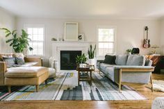 a living room filled with furniture and a fire place in the middle of a room