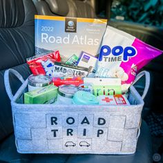 the road trip basket is filled with snacks and drinks