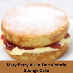 mary berry all - in - one victoria sponge cake on a white plate with the words mary berry all - in - one victoria sponge cake