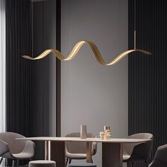 a dining room table with chairs and a light hanging over it