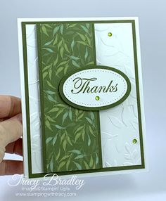 a hand holding up a thank card with leaves on the front and bottom, which reads thanks